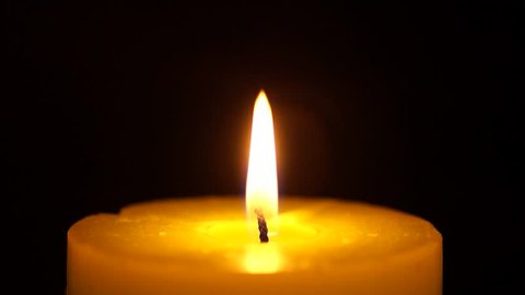 beautiful fire of a candle in a dark room, a warm yellow candle quietly burning in the dark, a candle burning in the dark, the fire of a candle in the dark