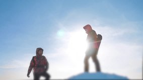 teamwork business concept victory help hands arm slow motion video. team group tourist hikers gives a helping hand. success win winter reached the top of the mountain. tourists climbers climb to the