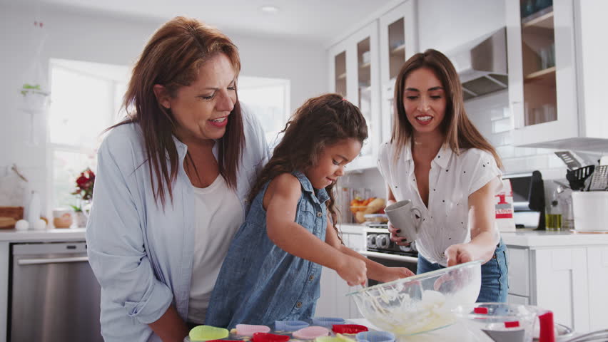 Filling young girl. A mother holding a Cake in her child’s hand arab.