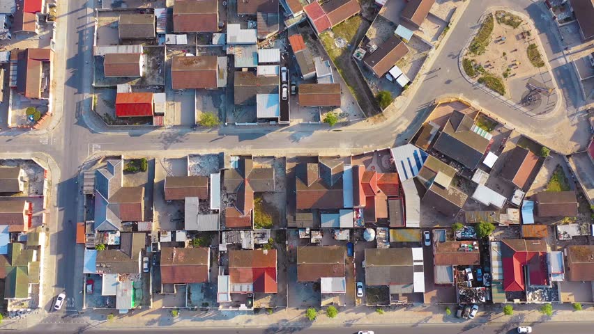 GUGULETHU, SOUTH AFRICA - CIRCA 2018 - Straight down high aerial contrasting neighborhoods above ramshackle township of Gugulethu.
