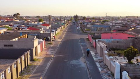 GUGULETHU, SOUTH AFRICA - CIRCA 2018 - Aerial over street scene in township of South Africa, with people walking on streets.