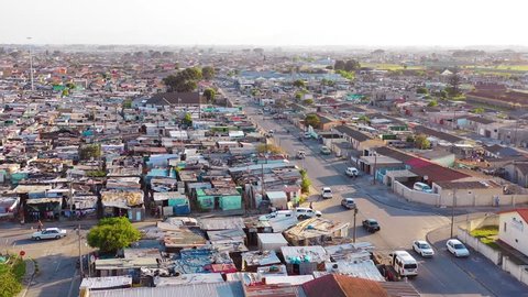 GUGULETHU, SOUTH AFRICA - CIRCA 2018 - Aerial over townships of South Africa, with poverty stricken slums, streets and ghetto buildings.