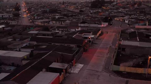 GUGULETHU, SOUTH AFRICA - CIRCA 2018 - Spectacular aerial over township in South Africa, vast poverty and ramshackle huts, at night or dusk.