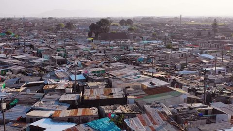 GUGULETHU, SOUTH AFRICA - CIRCA 2018 - Aerial over ramshackle tin roofs of Gugulethu, one of the poverty stricken slums.