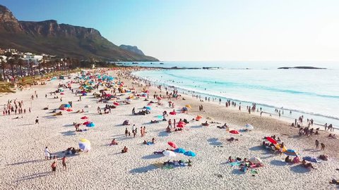 CAPE TOWN, SOUTH AFRICA - CIRCA 2018 - Spectacular aerial over a crowded and busy holiday beach at Camps Bay, Cape Town, South Africa.