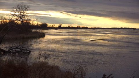 KEARNEY, NEBRASKA - CIRCA 2018 - Establishing shot of the Platte River in golden light in central Nebraska near Kearney.
