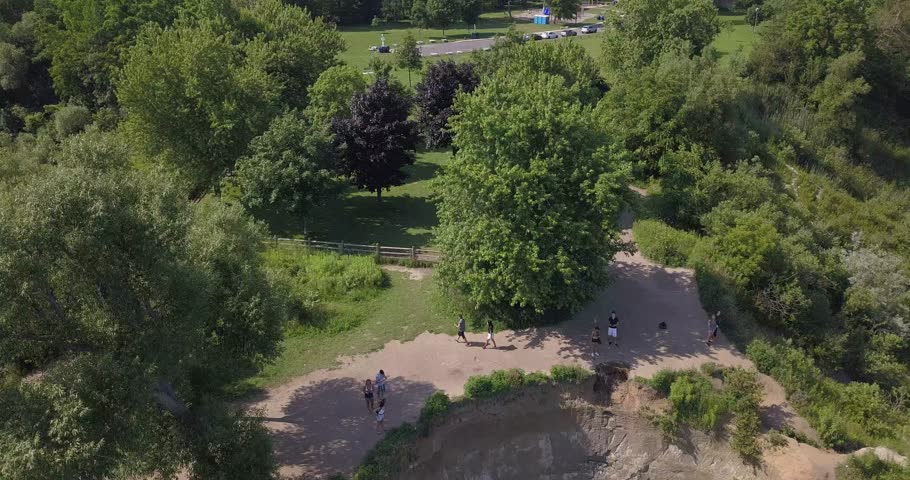 Aerial view of huge cliff. Drone flies backwards to slowly reveal the cliff. Very cool!