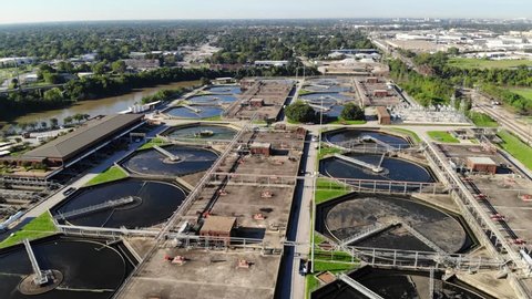 Aerial Drone Footage of a Sewage Treatment Plant next to Buffalo Bayou with the Houston Medical Center and the City of Houston Skyline in the Background