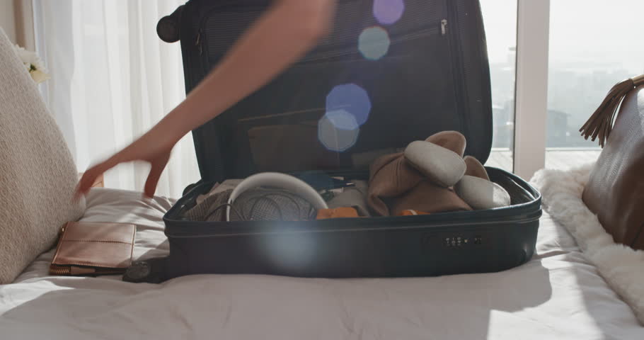 Travel woman packing suitcase getting ready for road trip preparing luggage for vacation