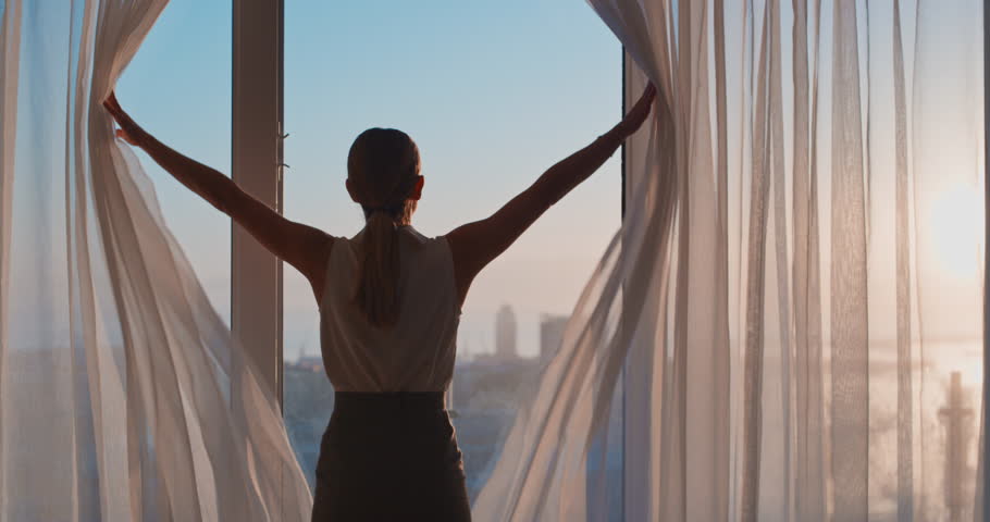business woman opening curtains in hotel room looking out window at fresh new day successful independent female planning ahead at sunrise Royalty-Free Stock Footage #1024548077