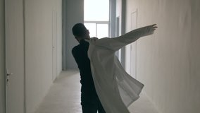 Doctor puts dressing gown on the go - Powered by Shutterstock - Get 15% off with code: PIKWIZARD15