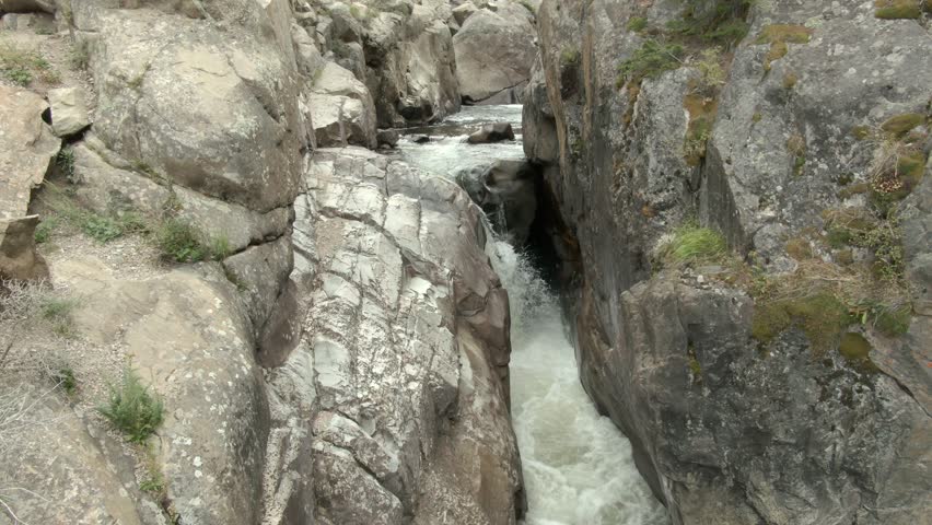 Aerial view of river and waterfall in a canyon outside Fort Collins, CO at the end of summer