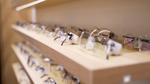 Glasses for sight. Sunglasses in a store. A collection of frames on the store shelf.