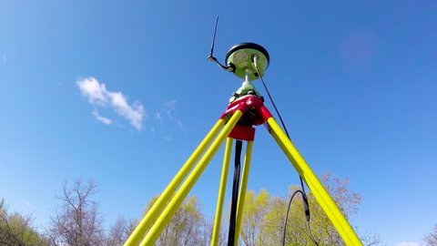 Moving zoom out Timelapse of Leica GNSS (GPS) base station for land surveying with cloudsing by, on a summer day in St. Francis Xavier Manitoba Canada.