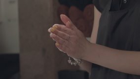 Woman rubs hands with cream. Slow Motion Video