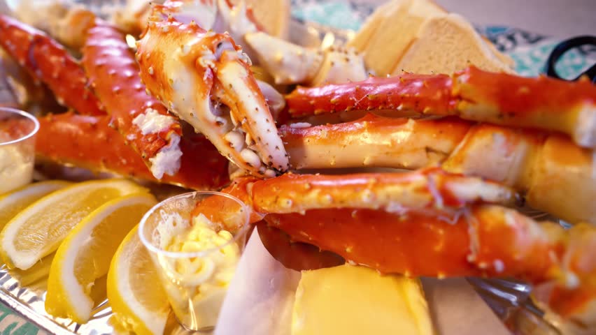Red king crab legs with fresh lemon slices. Delicious seafood and luxury restaurant menu.