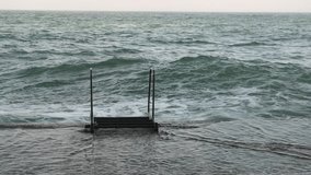 Storm on the sea, flooded pier