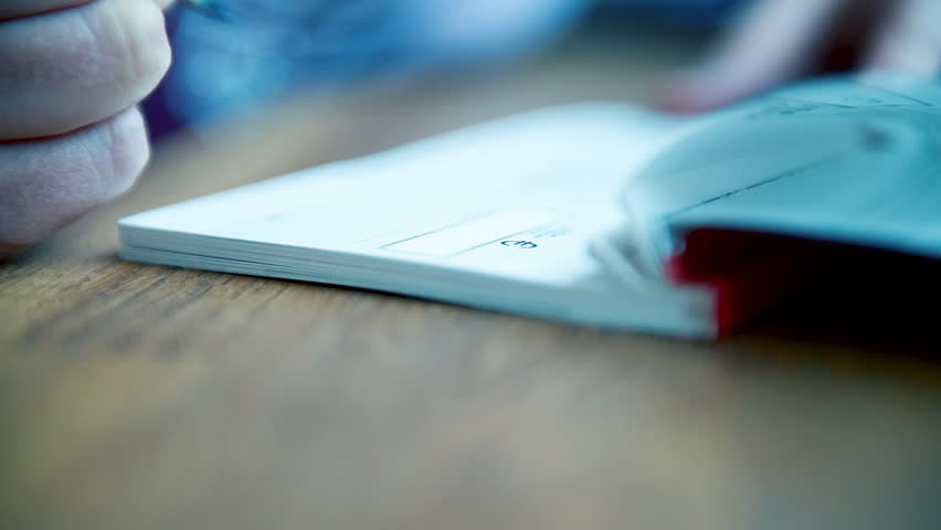macro close-up detail of young business woman filling a banking cheque check writingwith luxury fountain pen the requested data in the luxury first class checkbook Royalty-Free Stock Footage #1024582382