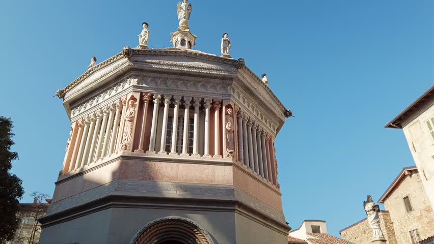 Panning Octagonal baptistery of Basilica of Santa Maria Maggiore in Citta Alta, Bergamo, Italy. Historical architecture and medieval church of Old town or Upper City in Bergamo.