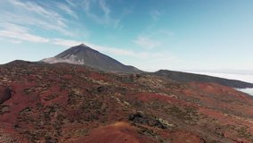 Aerial shot. Peak of the mountain volcano. Red volcanic landscape. Canary Islands, Teide volcano. National park. The concept of colonization of Mars.
