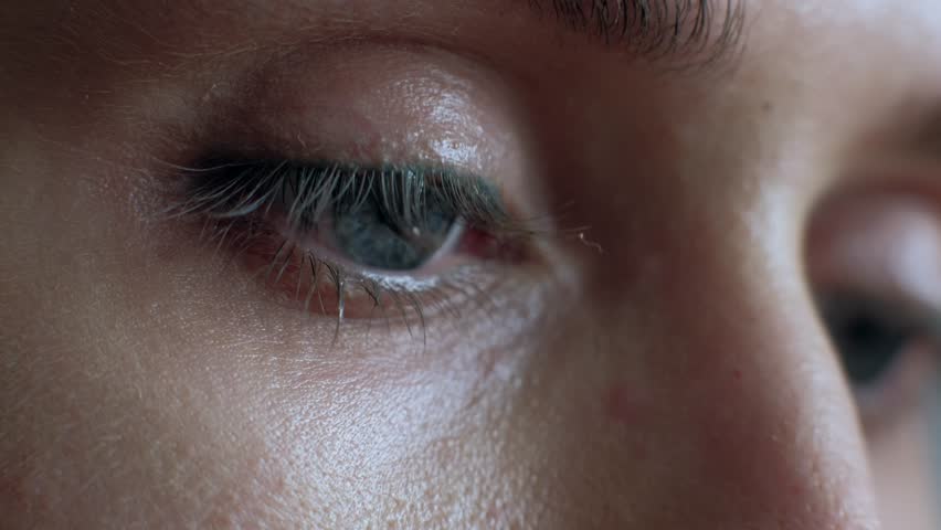 The female eye cries and tears are flowing macro video. Close-up woman eye cries and tears flow. 4k. Macro shoot. Royalty-Free Stock Footage #1024586726
