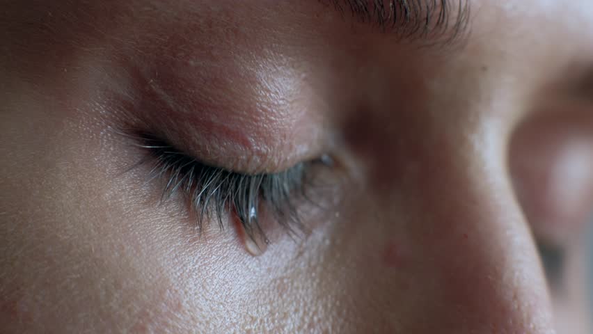 The female eye cries and tears are flowing macro video. Close-up woman eye cries and tears flow. 4k. Macro shoot. | Shutterstock HD Video #1024586726