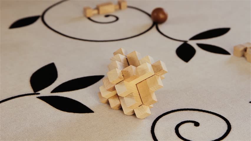Man and Woman Hands Alternately Picking Wooden Puzzle on Tablecloth, Close Up