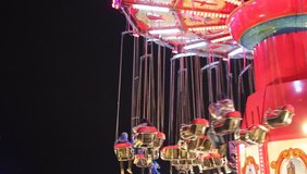 swing fairground funfair ride at night. swing fairground funfair ride carousel merry-go-round swings seats moving Chair-O-Planes or swinger with filter stock stock, footage, video, clip