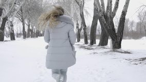 Girl Is Running Through The Snow At Cold Winter
