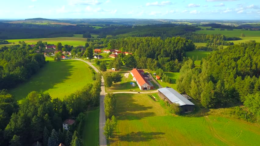 Flight over village in countryside. Summer country in Novohradske mountains (Novohradske hory). South Bohemia in Czech republic, European union.