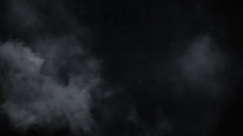 Spooky magic halloween. Atmospheric smoke VFX element. Haze background. Abstract smoke cloud. Smoke in slow motion on black background. White smoke slowly floating through space against black bg