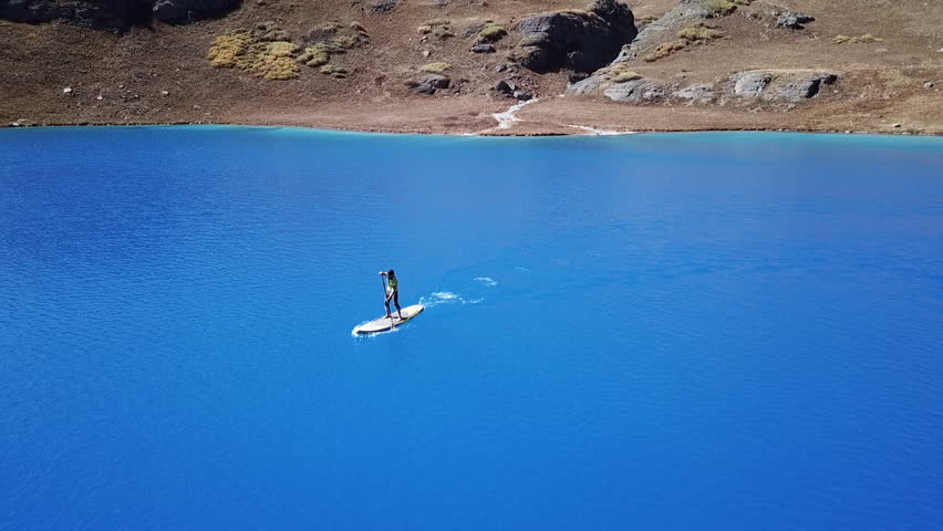 Pan Right to Left: Paddle Boat Fast Across the Ice Lake in Colorado USA