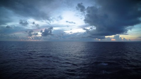 A dark, moody sky over the open sea.