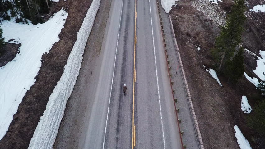 Aerial Tilt Up: Man Skateboarding on the Streets of Lander Wyoming