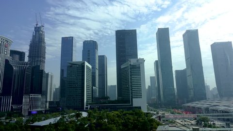 SHENZHEN JAN 2018: Timelapse of Shenzhen CBD during the day. Daytime time lapse of office buildings windows with people working in skyscrapers in Shenzhen, China.