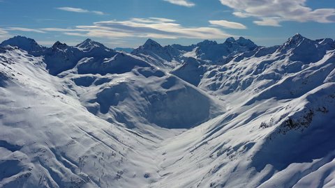 Aerial panoramic view of Alps, landscape panorama of snowy mountain range in winter, sunny day with blue sky - Alps from above, Livigno, Italy, Europe
