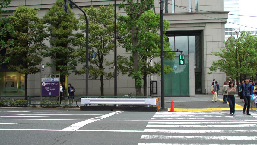 TOKYO - CIRCA MAY, 2017: Tokyo metro and building train Tokyo station, people at a pedestrian crossing. Tokyo station it is the main intercity railway station.