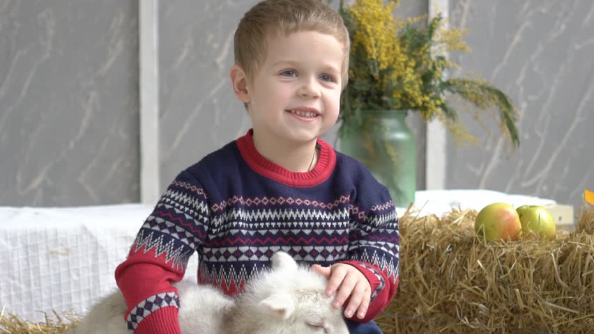 Baby Boy Plays With A Goat