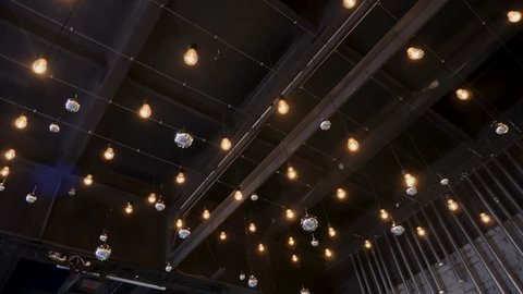 dark ceiling with hanging bright lights over the great hall