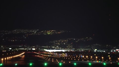 Small jet plane landing scene in the night.