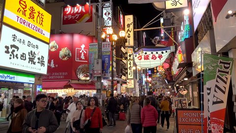 OSAKA,  NAMBA / JAPAN - NOVEMBER 4, 2018:
Crowd at the Dotonbori street near Kani Doraku Crab & Golden Dragon Ramen  restaurants by night.
