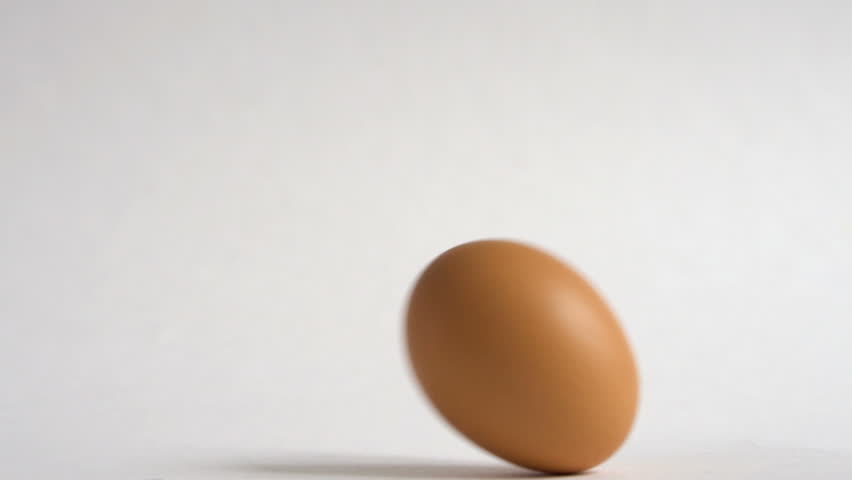 Egg are rolling on the white table. Easter eggs background. Can be used as looped. Royalty-Free Stock Footage #1024632035