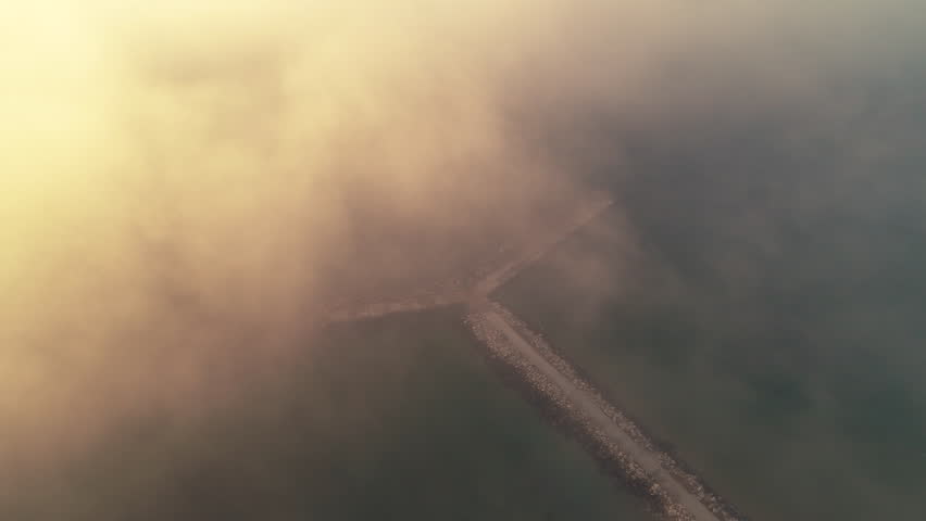 Fog over the sea. Sun and sunrise above the clouds. Aerial view.  | Shutterstock HD Video #1024632803