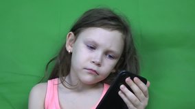 Little girl watching video on a smartphone