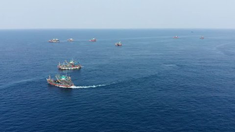 Unsustainable fishing - aerial view of a flotilla of large fishing trawlers operating together in a shallow ocean (Black Rock, Mergui Archipelago)