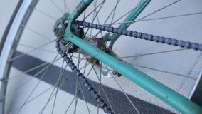Close up view of a green track fixed retro bicycle on a velodrome 
