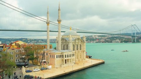 Aerial view of Ortakoy Camii, with a background view of Bosphorus Bridge on a cloudy day. Shot with Panasonic GH4 at UltraHD. 