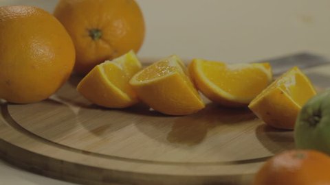 Orange cuts. Slices of oranges lie on a wooden board. Juicy Oranges.  Close up of orange fruit. 