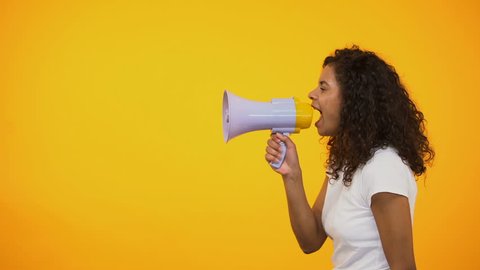 African-American woman with megaphone announcing sensation news, shop discounts