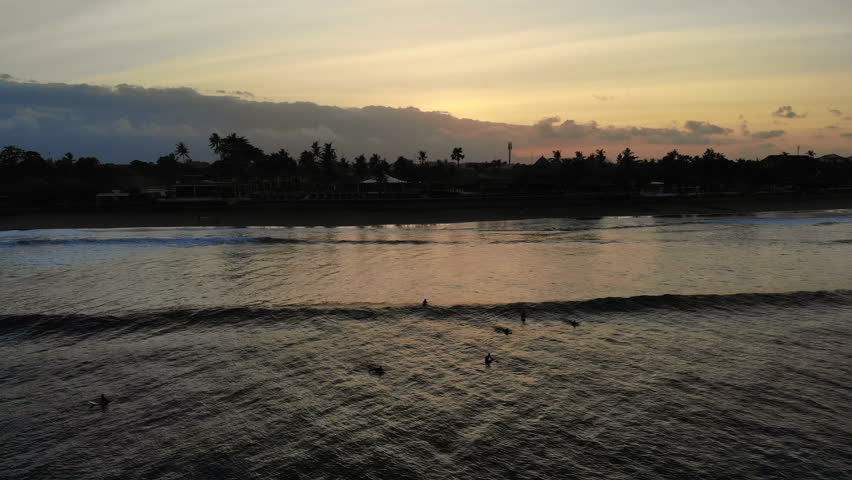 Flyover Sunrise Surfers Catching Waves At Dawn.